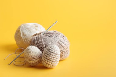 Çizgili şirin desenli örülü yumurtalar, sarı arka planda iplik desenli pastel renkler. Banner, kopyalanmış Paskalya kartı. Yatay