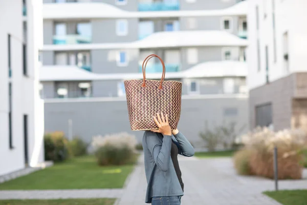 young woman outside a bag instead of  a head