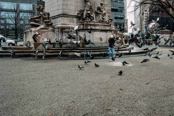 少女在中央公园里跑着穿过鸽子 — 图库照片