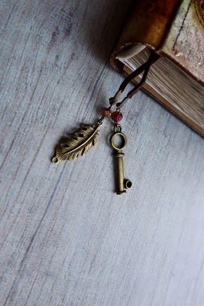 Bookmark key and feather in handmade notebook