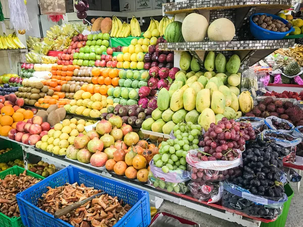Variety of packaged colorful fruits for sale in Mexico City market.