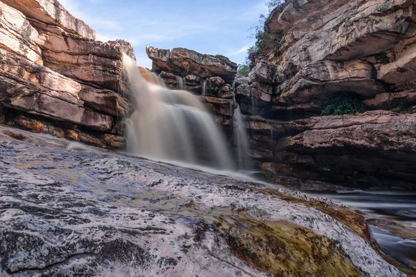 Waterfall among rock walls in long exposure