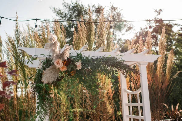 White Wedding Arch/Arbor with Floral Decor and String Lights