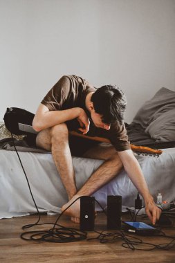 Gitarist gitarını ayarlıyor.