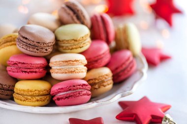 plate full of pretty pastel macarons with Christmas background clipart