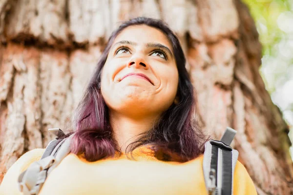 Genç kadın ağaçta dinleniyor.