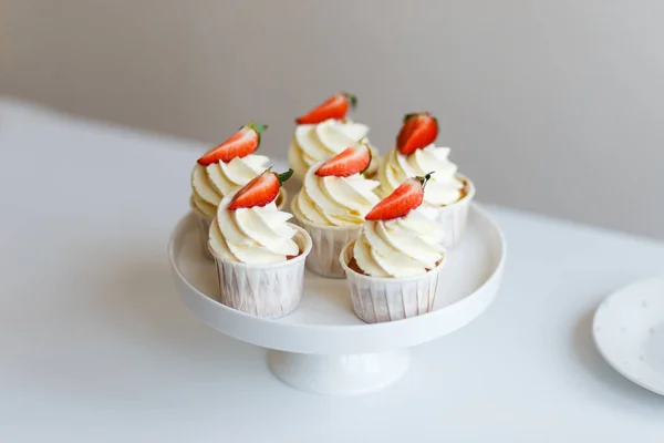 cream cupcakes with fresh strawberries freshly prepared by pastry chef