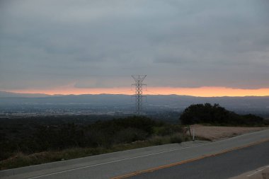 Dusk skyline view with silhouette of a powerline