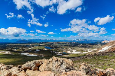 Plateau in the Beartooth Mountains under a partly cloudy blue sky clipart