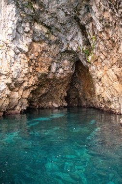 Kotor 'da turkuaz denizli bir mağaranın kayalık manzarası