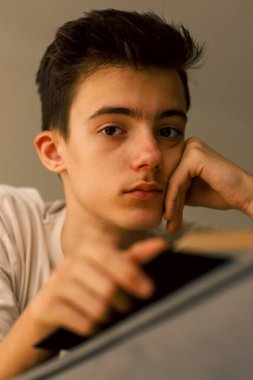 Portrait of teenager boy with book clipart