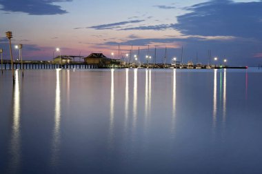 Akşamları liman ve liman sakin suları yansıtıyor.