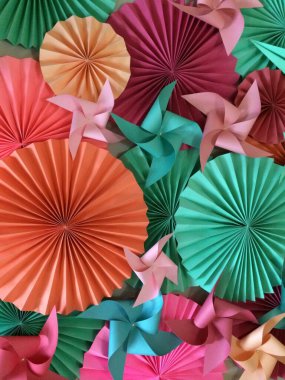 Colorful Paper Pinwheels and Rosettes in Festive Display clipart