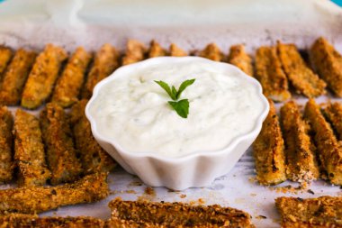 Golden zucchini fries with creamy dip clipart