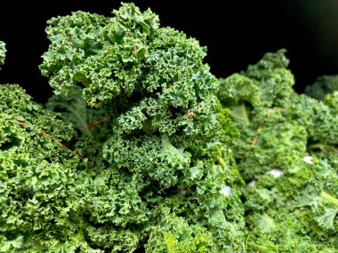 Close-up of fresh bunches of kale at NYC market clipart