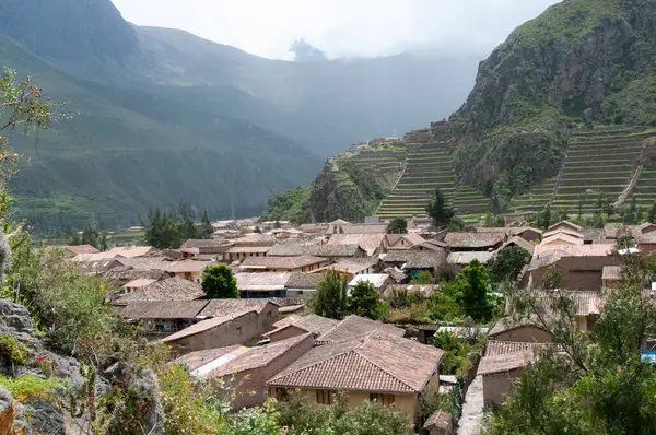 Stock image Overlooking a rustic Andean village with terraced hills and a mo