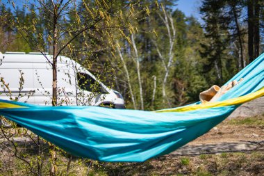 Bright Hammock with Campervan in Background, Northern Ontario clipart