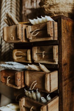 Aestetic scene of candles stored in rustic wooden drawers clipart