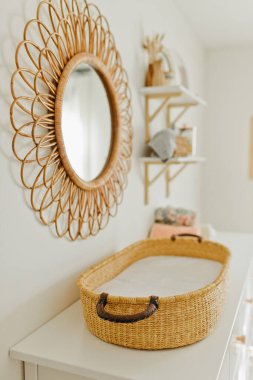 Wicker basket and mirror in little girl's nursery clipart