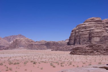 Desert rock formations in the middle east with sand and sky clipart