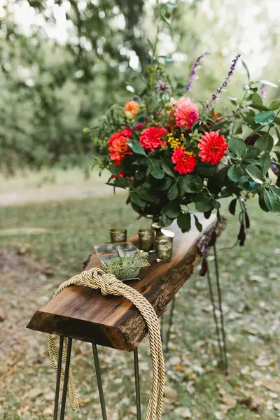 stock image Flower arrangement at wedding with tie the knot rope and glass box