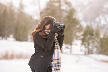 Women taking photos in the snow in lake tahoe clipart