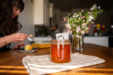 Sıcak mutfak sahnesi, bal kavanozu, taze pasta ve çiçek..