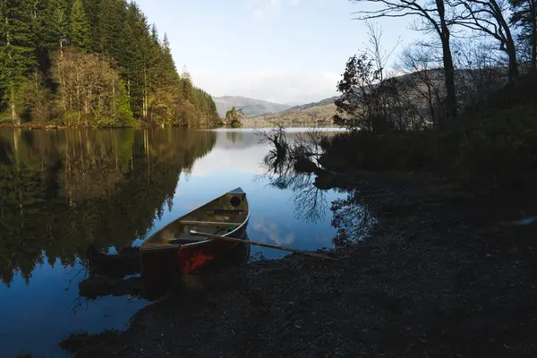 stock image Canoe at lake shore in the morning