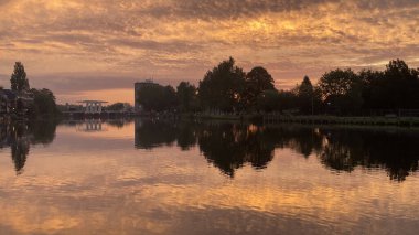 Stunning sunrise reflected in Spaarne River in Haarlem clipart