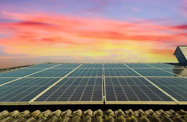 stock image Solar panels producing clean energy on a roof of a residential house 