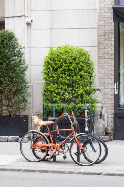 Bicycles chained up in Lower Manhattan clipart