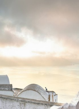 Two cats on the roof of a house in Santorini greet a sunrise clipart