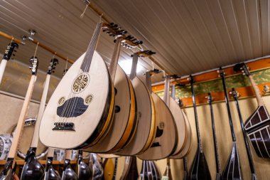 A row of guitars hanging from the ceiling