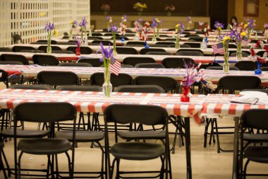 Banquet tables with flowers and American flags clipart