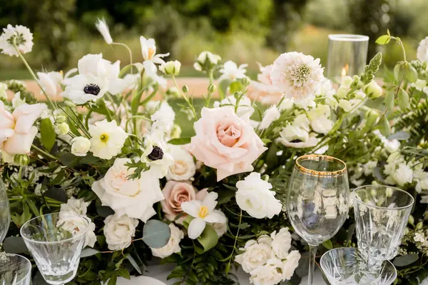 stock image Close up of floral centerpiece with pink roses and white anemones