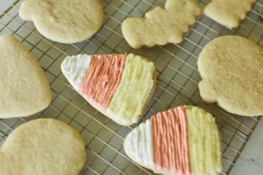 Frosted Halloween cookies on cooling rack, candy corn clipart