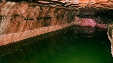 Ancient therapeutic pool dug inside a salt mine in Khewra, Pakistan clipart