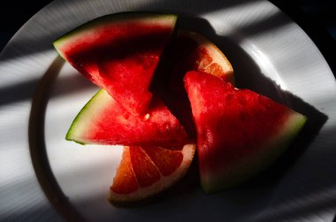 pieces of watermelon and grapefruit in strong colours clipart