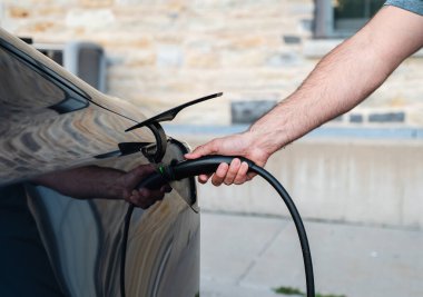 EV şarj aletini dışarıdaki elektrikli araca takmayı kapat..