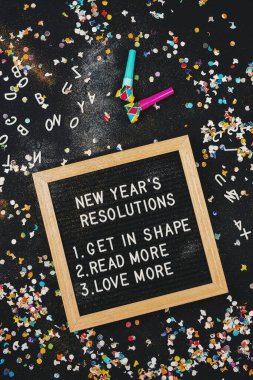 New Year's Resolutions Board Surrounded by Confetti clipart