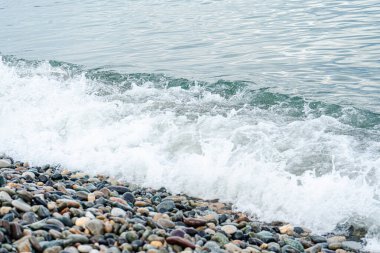 Sea waves on the pebbles shore clipart