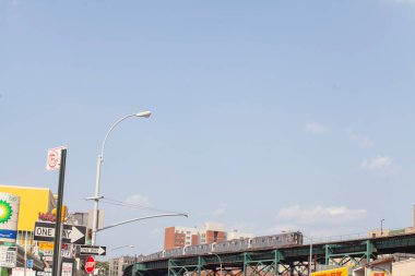 Subway train on the high line lots of blue sky above clipart