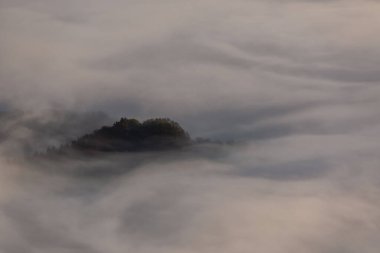 Aramaio valley under the clouds in the morning clipart