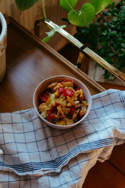 Colorful vegetable stir-fry served in a bowl on a kitchen table, clipart