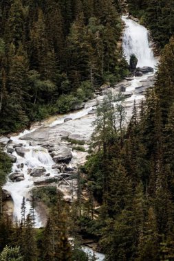 Alaskan waterfall in the mountains clipart