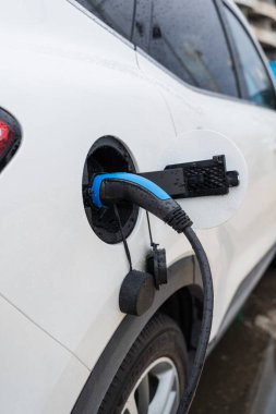 Şarj prizi olan beyaz elektrikli araba.