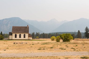 Scenic view of smoky Fisher Peak  from Fort Steele heritage site clipart