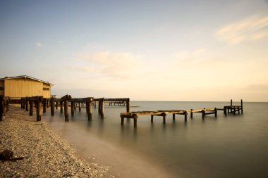 Altın saat, hasarlı ahşap kasırganın üzerine ılık bir parıltı saçar