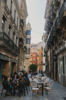 Tourist sitting in ally in Valencia, Spain clipart