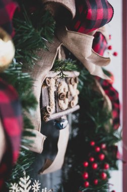 Close up of Christmas wreath with burlap, buffalo plaid, and joy sign clipart